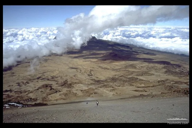 View from Gillman's point (crater rim) towards the saddle between Kibo and Mawenzi. Mawenzi is hidden in the clouds.