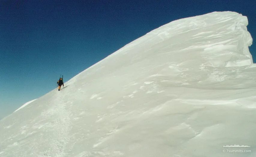 Jose traversing a giant cornice at the summit ridge