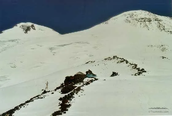 Ruins of the burned Priut 11 hut and the Elbrus summits
