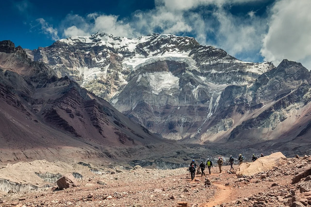 Trekkers approaching Aconcagua's snow-covered south face in Aconcagua Provincial Park